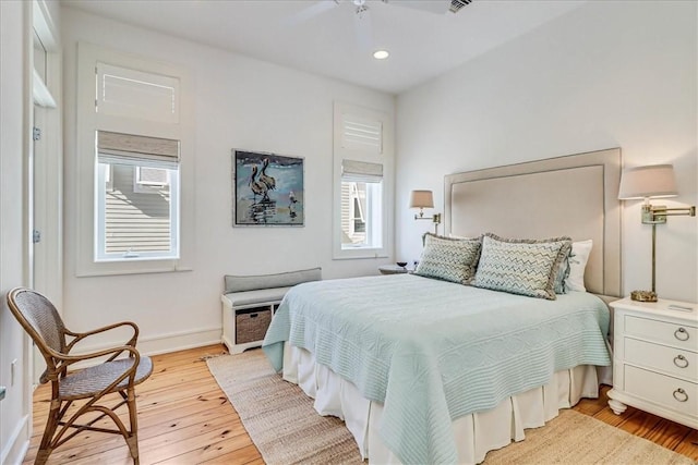 bedroom with ceiling fan and light hardwood / wood-style flooring