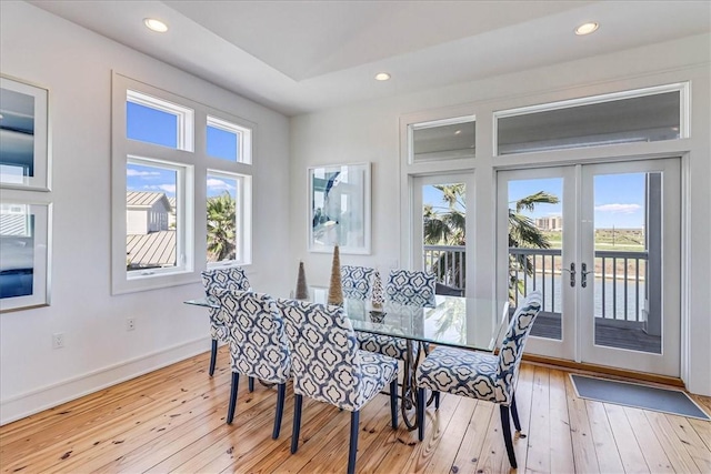 dining area featuring light wood-type flooring and french doors