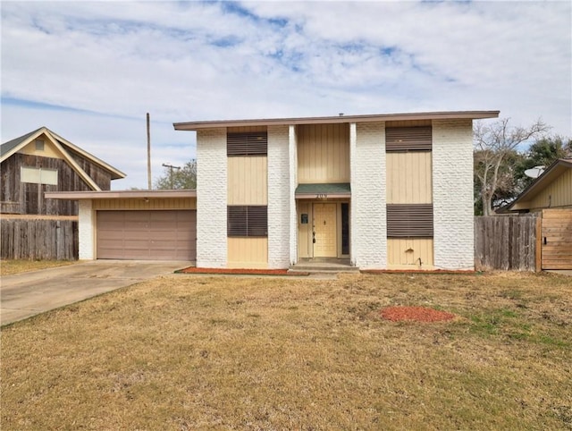 view of front of house with a garage and a front lawn