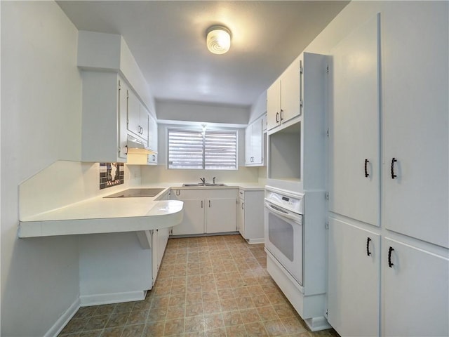 kitchen featuring white cabinetry, white oven, sink, and black electric cooktop