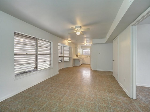 unfurnished living room with ceiling fan