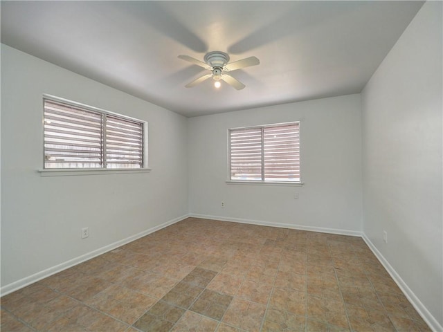 empty room featuring ceiling fan and a healthy amount of sunlight