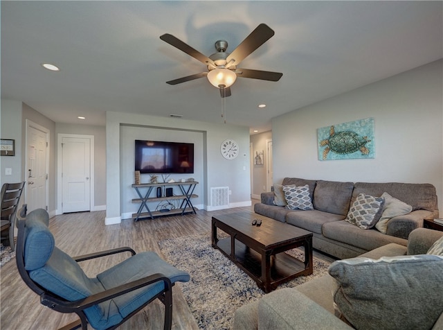 living room with hardwood / wood-style flooring and ceiling fan