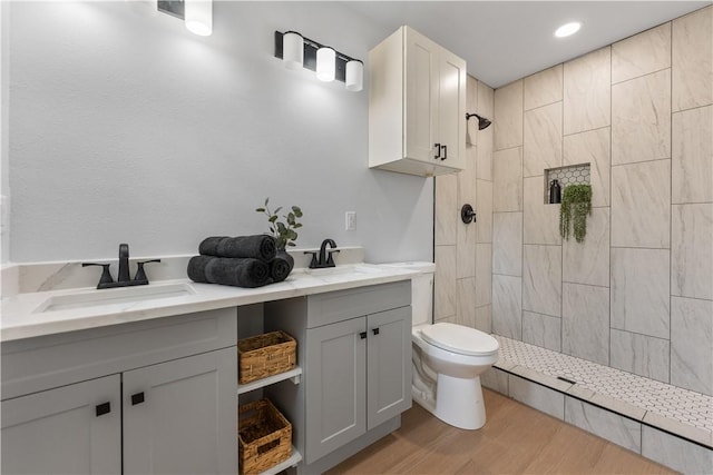2809 Tarlton St, Corpus Christi, TX 78405 - full bathroom with double vanity, tiled shower, wood finished floors, and recessed lighting