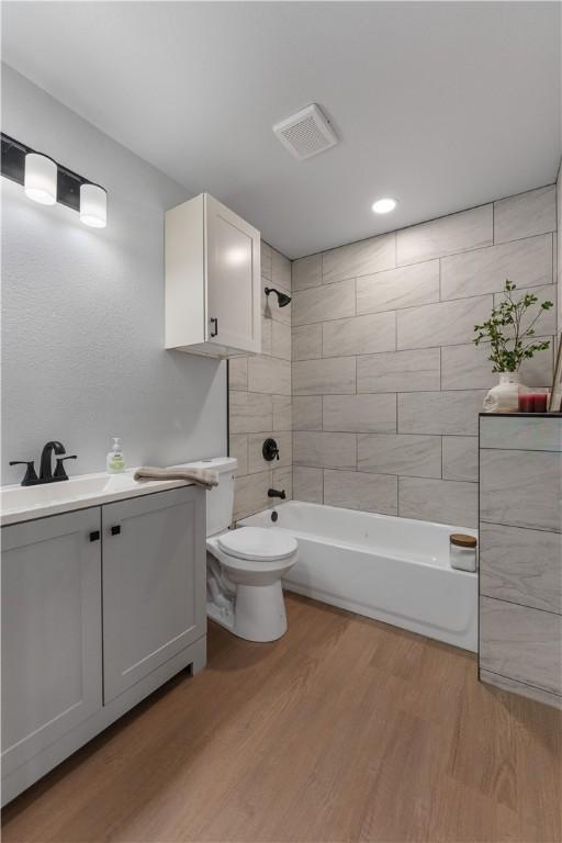 2809 Tarlton St, Corpus Christi, TX 78405 - full bath featuring vanity, wood finished floors, washtub / shower combination, and recessed lighting