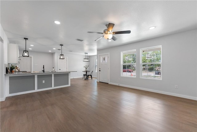 2809 Tarlton St, Corpus Christi, TX 78405 - unfurnished living room with a ceiling fan, dark wood finished floors, and recessed lighting