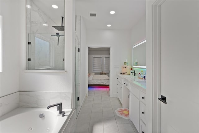 bathroom featuring shower with separate bathtub, vanity, and tile patterned flooring