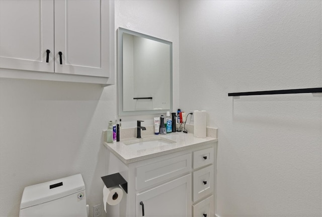 bathroom featuring toilet and vanity