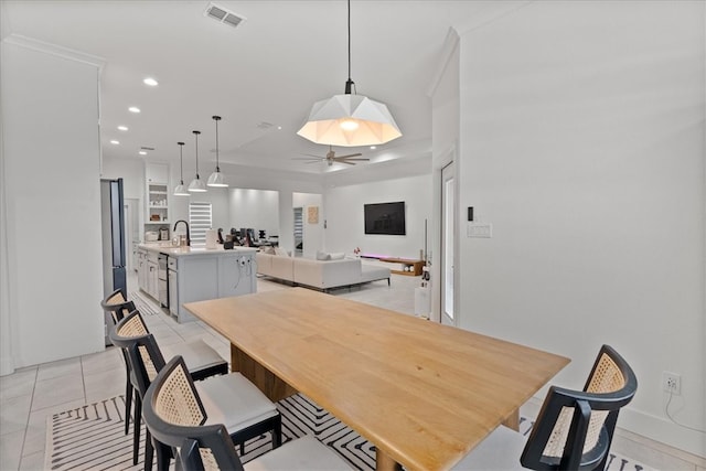 tiled dining room featuring sink and ceiling fan