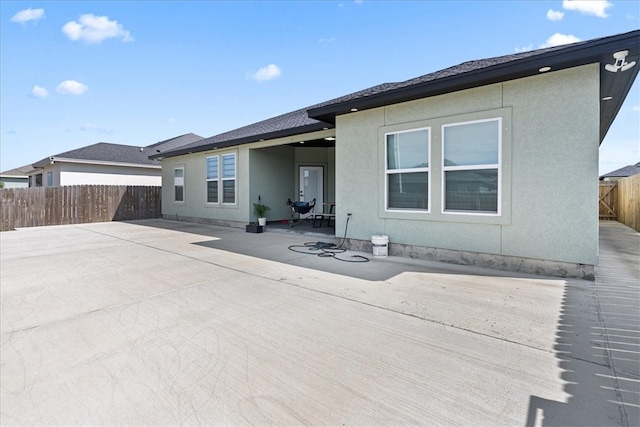 rear view of property featuring a patio area