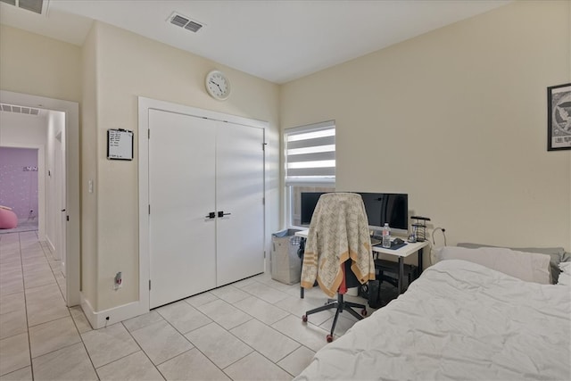 tiled bedroom featuring a closet