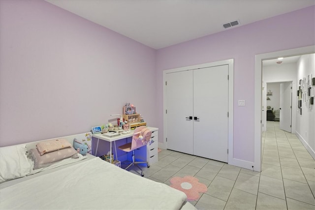 bedroom featuring light tile patterned floors and a closet