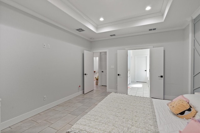 bedroom with ornamental molding and a raised ceiling