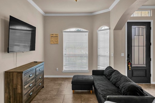 living room featuring ornamental molding and light tile patterned flooring