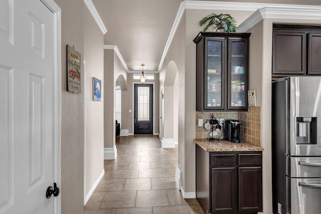 entrance foyer with light tile patterned floors and ornamental molding