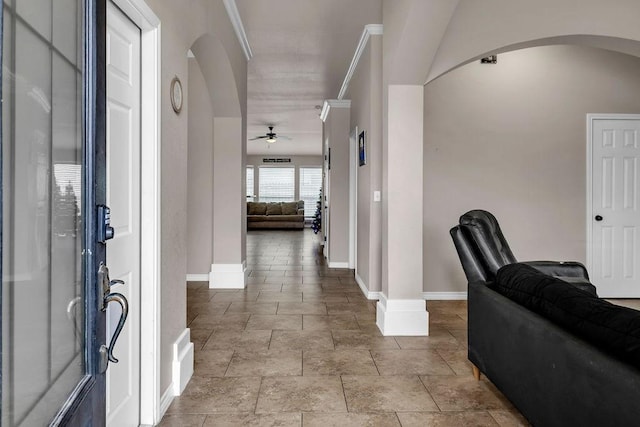 interior space featuring ceiling fan and ornamental molding