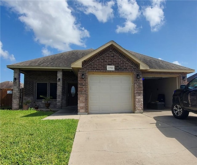 1703 Margaret Ln, Kingsville, TX 78363 - single story home featuring an attached garage, concrete driveway, brick siding, a front yard, and a shingled roof