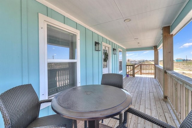 wooden deck featuring outdoor dining area