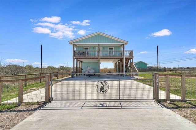 view of front of property with a carport, fence, decorative driveway, and a gate