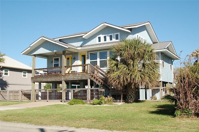 beach home with a front yard, a porch, fence, and a carport