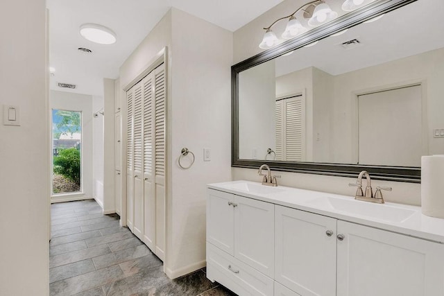 12308 Up River Rd, Corpus Christi, TX 78410 - full bathroom with a closet, double vanity, and baseboards