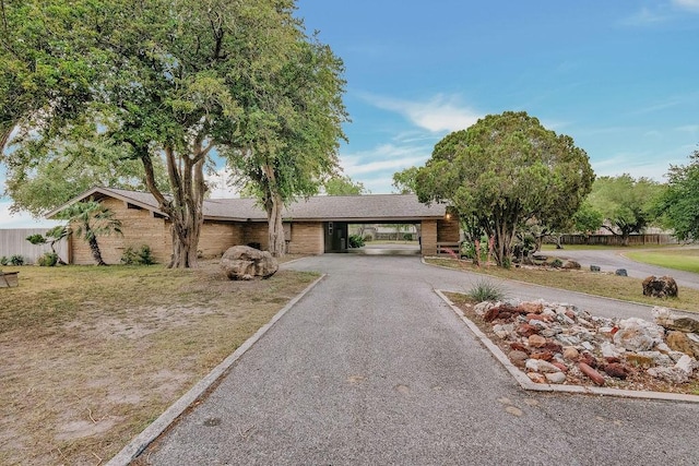 12308 Up River Rd, Corpus Christi, TX 78410 - view of front of house featuring driveway, brick siding, and an attached carport