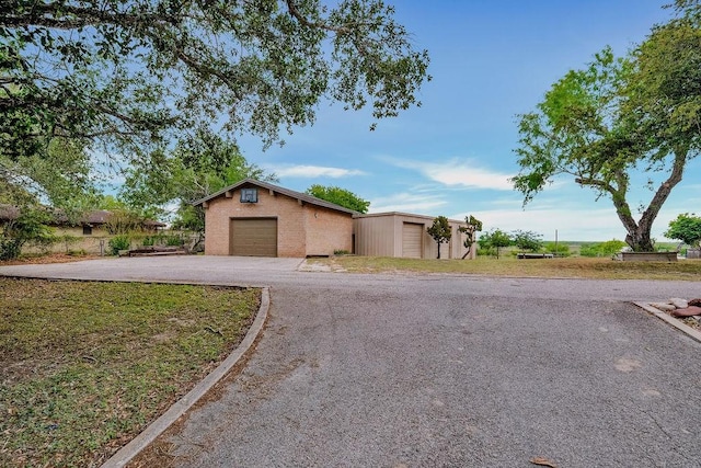 12308 Up River Rd, Corpus Christi, TX 78410 - view of front facade featuring an outbuilding, brick siding, a detached garage, and asphalt driveway