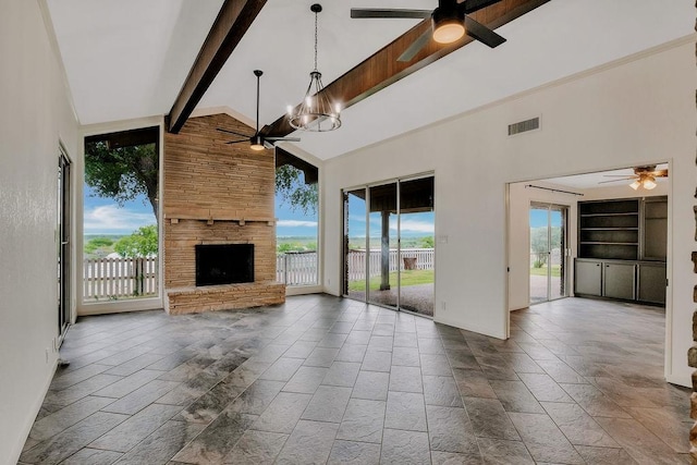 12308 Up River Rd, Corpus Christi, TX 78410 - unfurnished living room with ceiling fan, beam ceiling, high vaulted ceiling, a stone fireplace, and baseboards