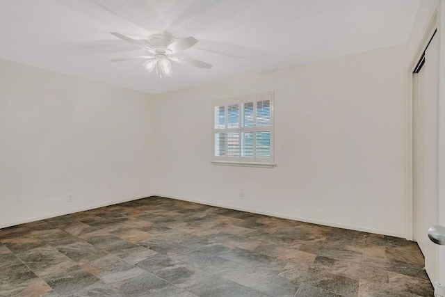 12308 Up River Rd, Corpus Christi, TX 78410 - spare room with stone finish floors, a ceiling fan, and baseboards