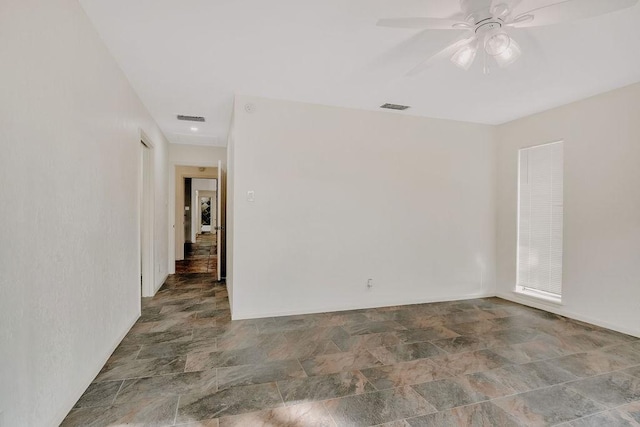 12308 Up River Rd, Corpus Christi, TX 78410 - empty room with stone finish floors, ceiling fan, and baseboards