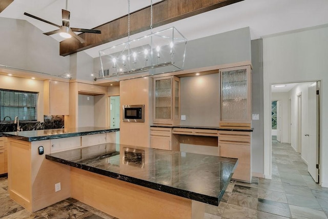 12308 Up River Rd, Corpus Christi, TX 78410 - kitchen featuring backsplash, built in microwave, glass insert cabinets, a ceiling fan, and a peninsula