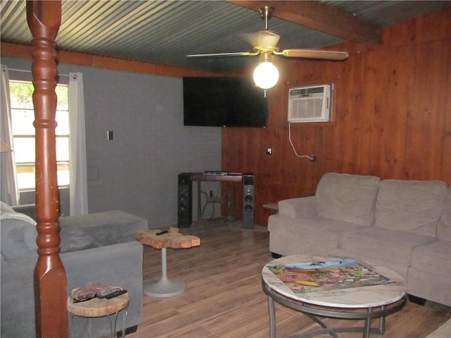 119 Horse Shoe Clf, Sandia, TX 78383 - living room featuring wood finished floors, ceiling fan, wood walls, a wall unit AC, and beam ceiling