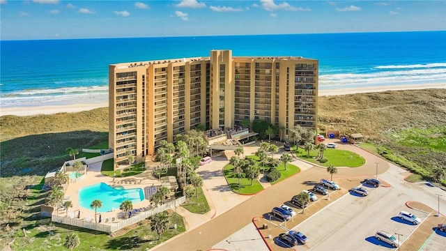 drone / aerial view with a water view and a view of the beach