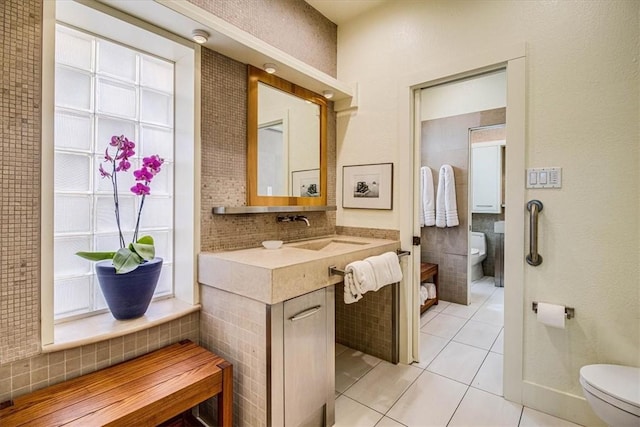 bathroom featuring decorative backsplash, vanity, toilet, and tile patterned floors