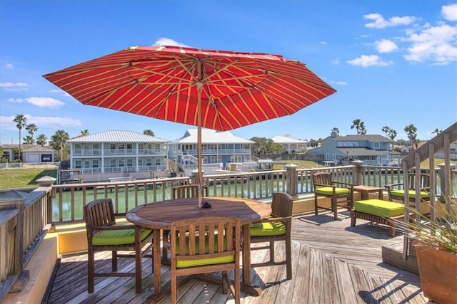 wooden deck with a water view and a residential view