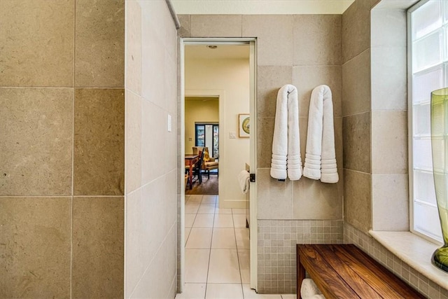 bathroom with tile walls and tile patterned floors