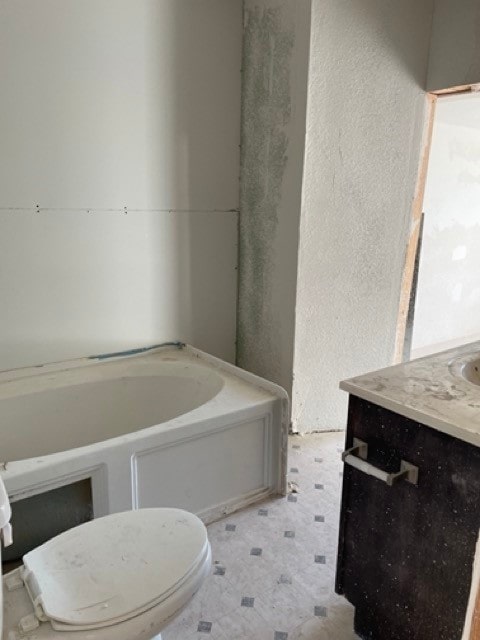 bathroom with vanity, toilet, and a bathtub