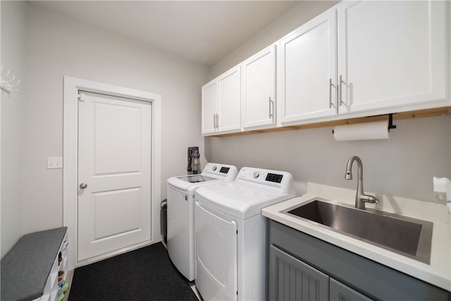 laundry room with cabinets, washing machine and clothes dryer, and sink