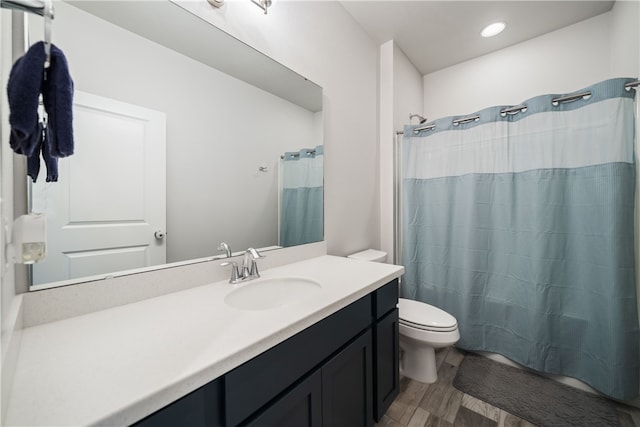 bathroom with vanity, a shower with curtain, wood-type flooring, and toilet