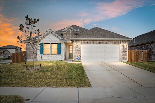 view of front of house featuring a garage and a lawn