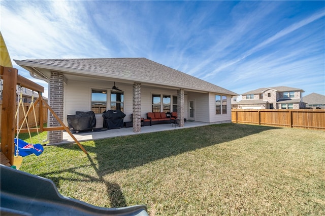 back of property with a patio area, ceiling fan, and a lawn