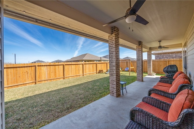 view of patio / terrace featuring a playground and ceiling fan