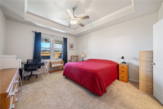 carpeted bedroom featuring crown molding, ceiling fan, and a tray ceiling