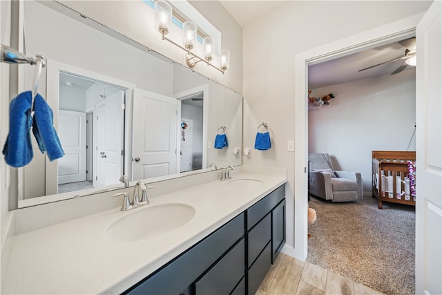 bathroom featuring vanity, wood-type flooring, and ceiling fan