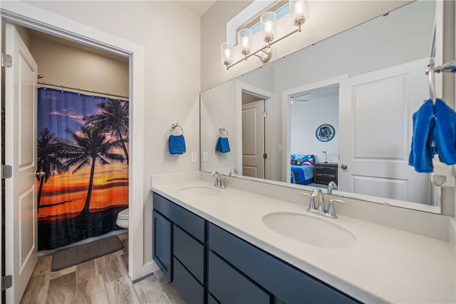 bathroom with hardwood / wood-style flooring, vanity, and toilet