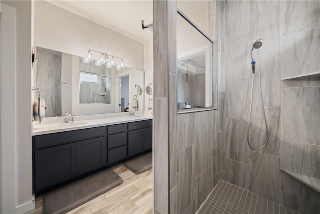 bathroom featuring vanity, tiled shower, and hardwood / wood-style floors