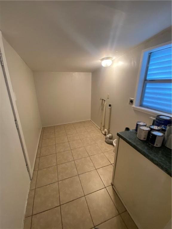 interior space featuring light tile patterned floors and electric dryer hookup