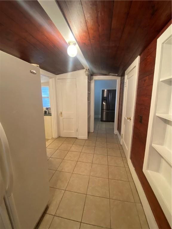 hallway with built in features, light tile patterned floors, and wooden ceiling