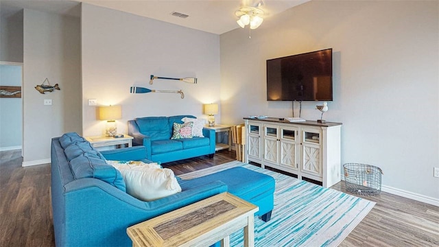 living room featuring hardwood / wood-style flooring and ceiling fan