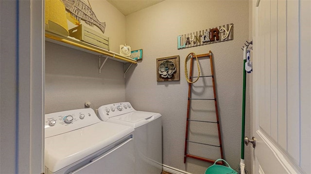 washroom featuring washer and clothes dryer